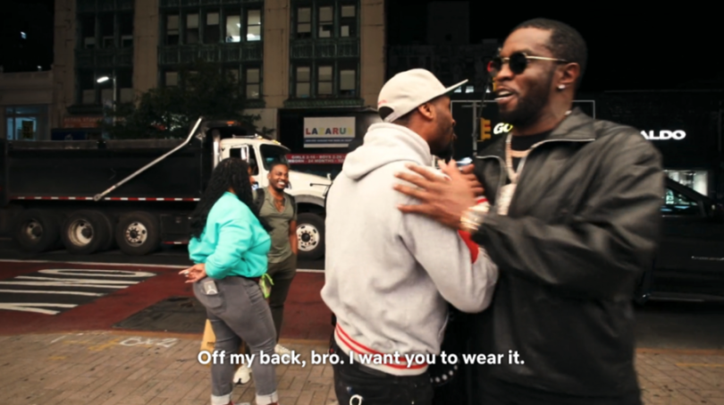 Sean Combs interacting with a fan.