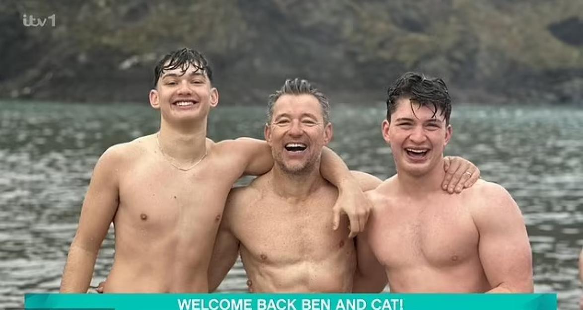 Ben Shepherd and his two sons in water, smiling.