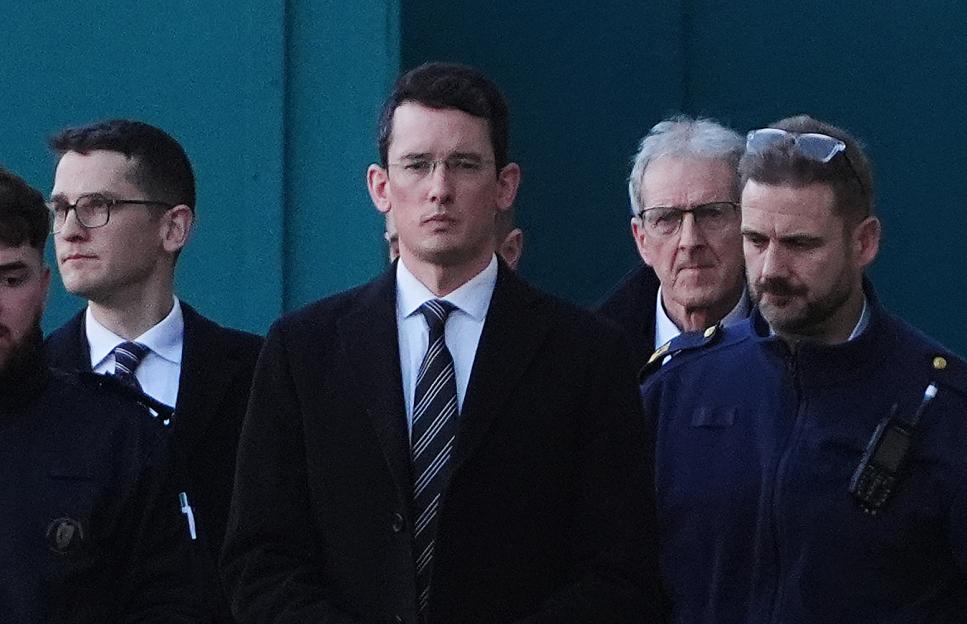 Enoch Burke (center) leaving the High Court with his brother Isaac (left) and father Sean (second right).