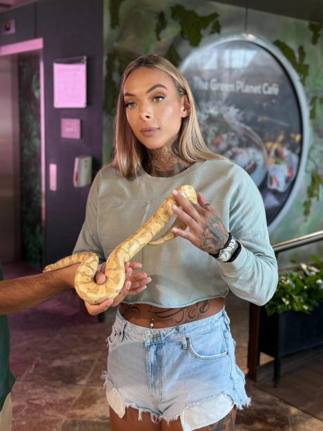 Alana Percival holding a patterned python.