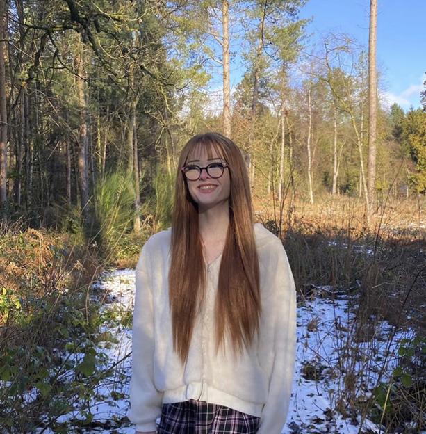 Brianna Ghey smiling in a forest.