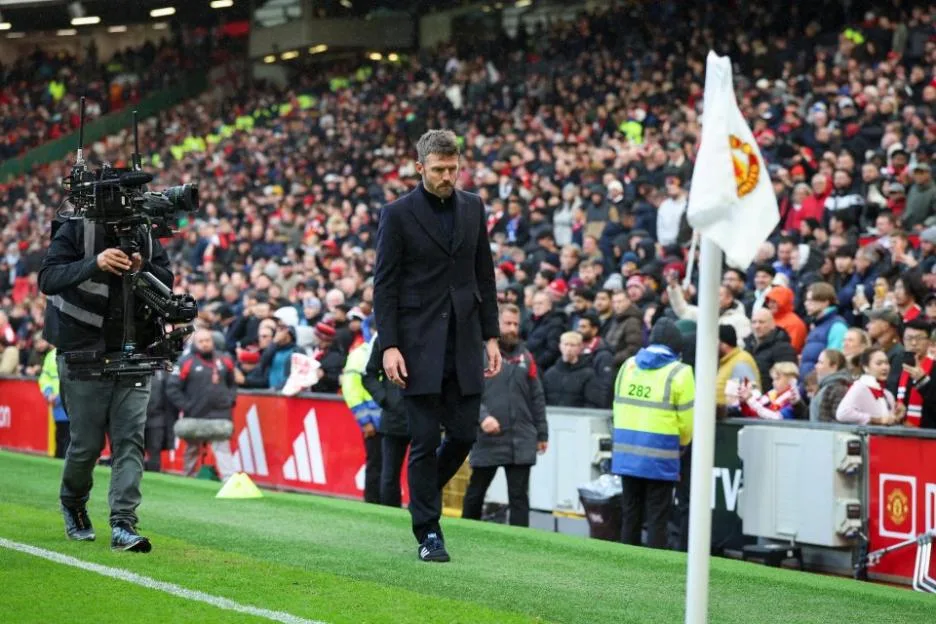 Manchester United head coach Michael Carrick leaves the pitch dejected during a match at Old Trafford.