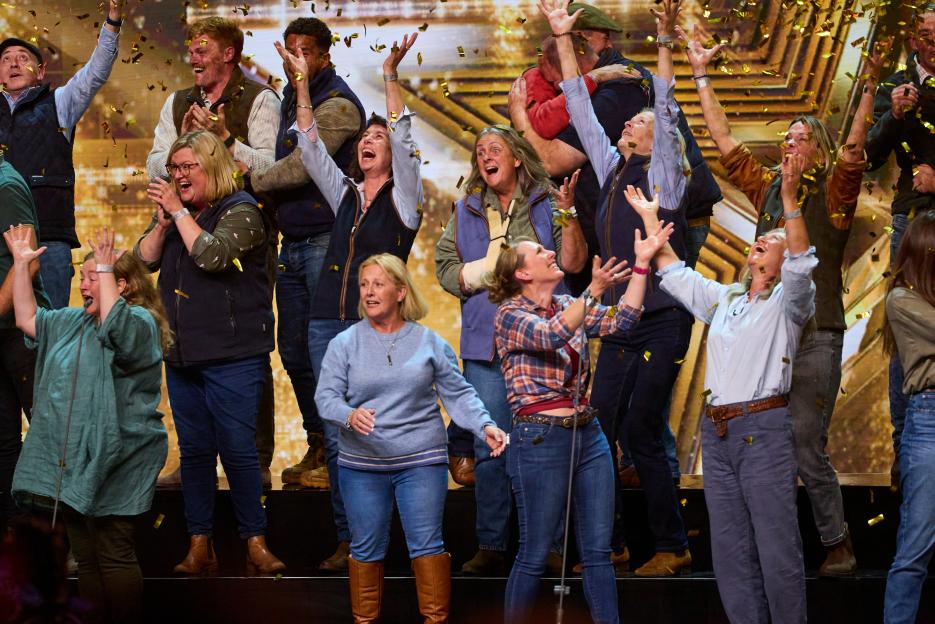 The Hawkstone Farmers Choir celebrating with confetti falling around them.