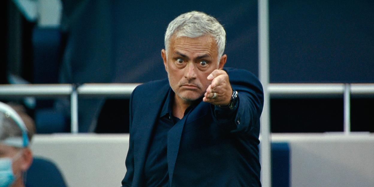 José Mourinho, with wide eyes and a serious expression, points directly forward.