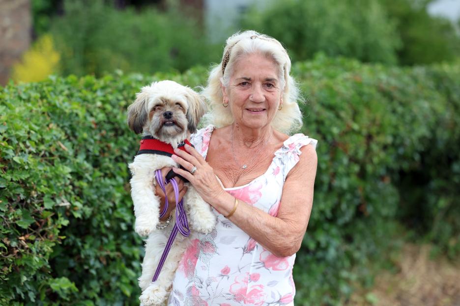 Jackie Holder, a local resident of RAF Linton On House, holding her small dog.