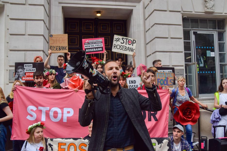 Zack Polanski speaking through a megaphone at a protest against the Rosebank oil and gas field.