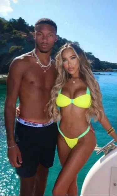 Roman Hackett and Dani Imbert posing together on a boat.