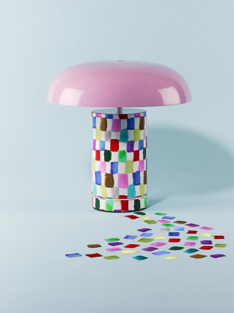 A lamp featuring a pink mushroom-shaped shade and a base adorned with vibrant rectangular brushstrokes.
