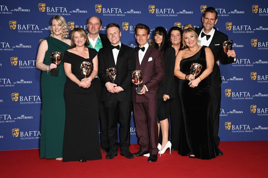 Claudia Winkleman and the team from "The Celebrity Traitors" posing with their Reality award at the BAFTA Television Awards.