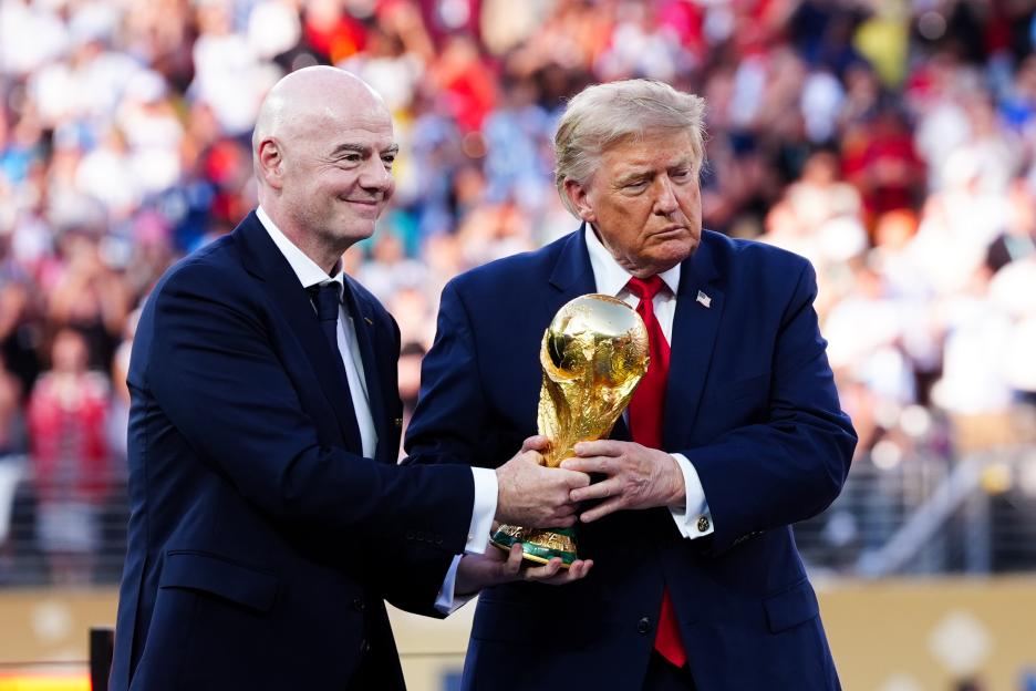 Gianni Infantino and Donald Trump holding the FIFA World Cup trophy.