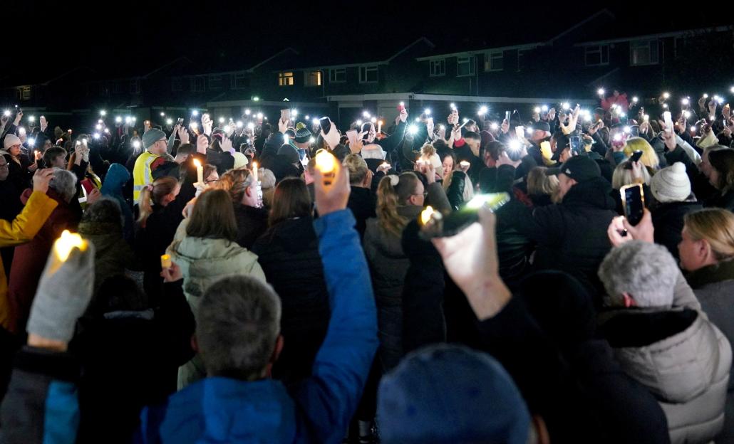 A large crowd of people holding lit candles and phone flashlights at a vigil in Weston-super-Mare.