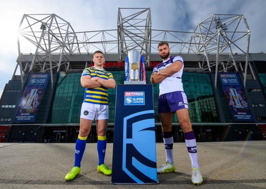Two rugby league players pose with the Super League trophy outside Old Trafford ahead of the Grand Final.