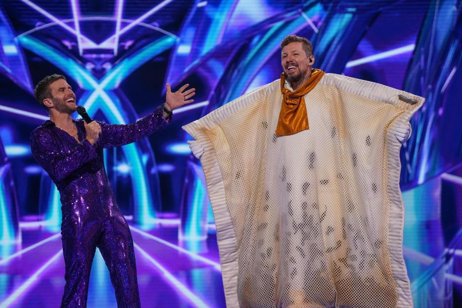 Joel Dommett and Professor Green on stage.