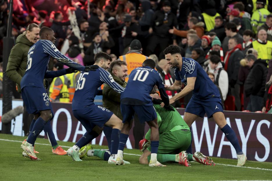 PSG players celebrating a victory after a penalty shootout against Liverpool FC.