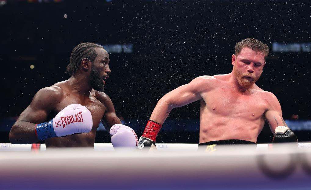 Terence Crawford lands a left punch on Canelo Alvarez during their super middleweight title fight.
