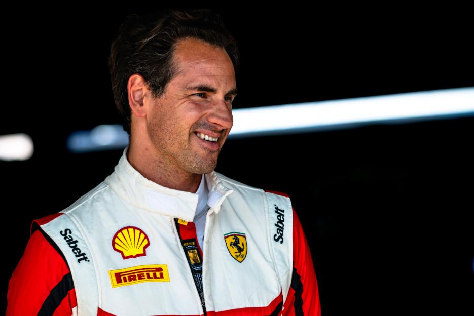 Adrian Sutil, former Formula 1 driver, smiling at the Ferrari Challenge 2022 at Hockenheim.