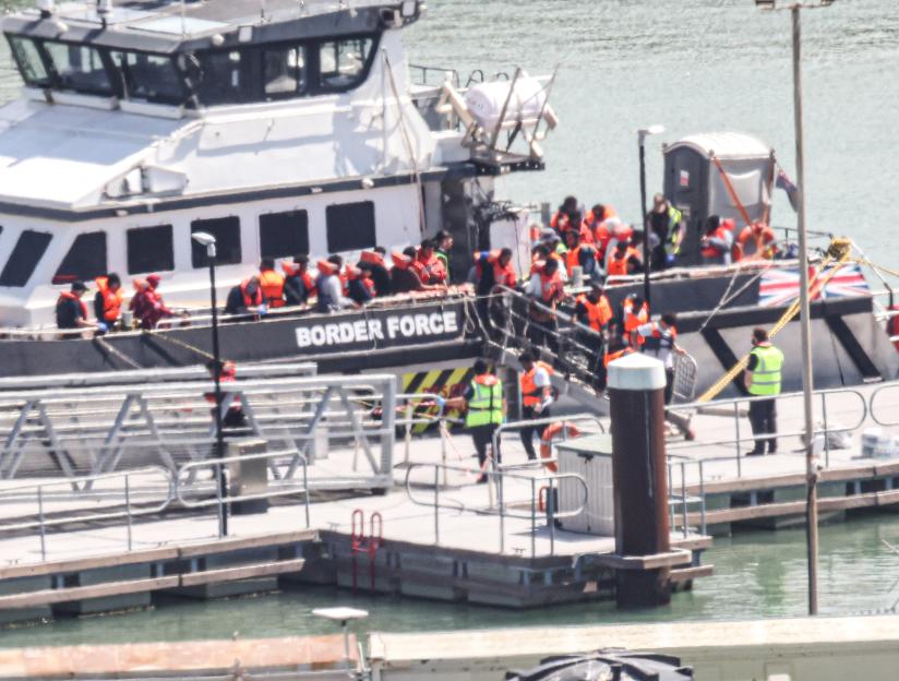 Migrants wearing life vests arriving in Dover aboard a Border Force boat.