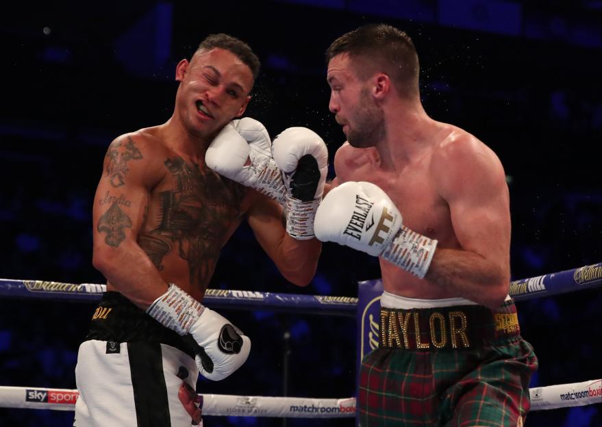 Regis Prograis getting punched in the face by Josh Taylor during their super-lightweight title fight.