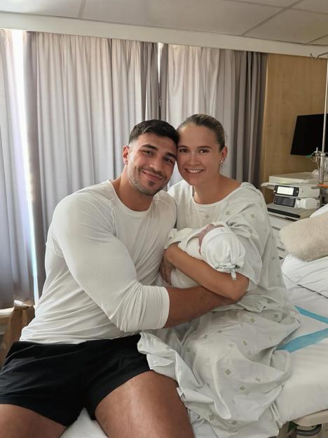 Molly-Mae and Tommy Fury pose for a photo with their newborn baby in the hospital.