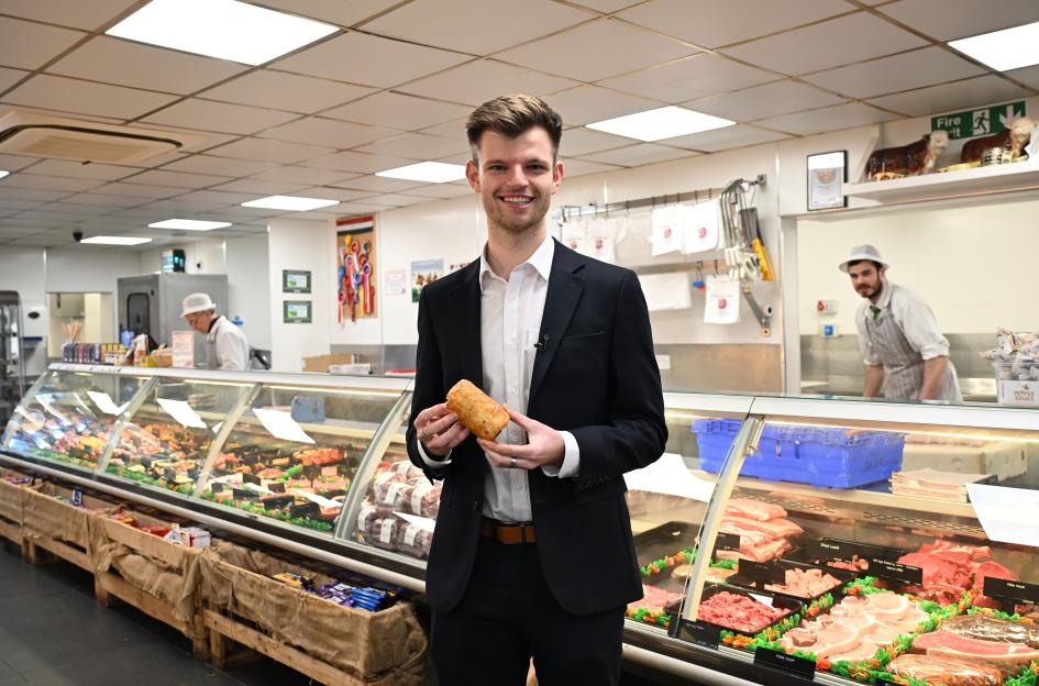 Reporter Sam Creed holds a standard sausage roll in a farmshop.