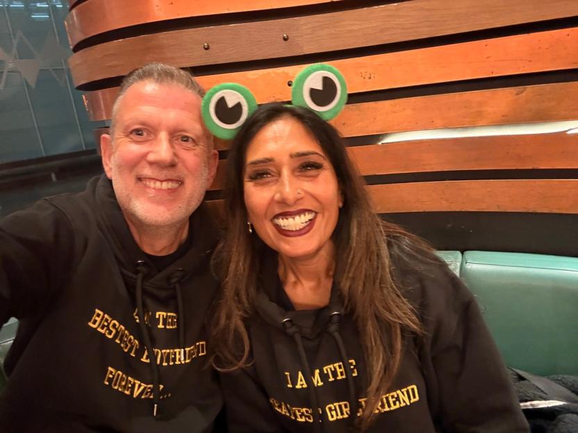 Couple wearing matching hoodies and frog-eye headbands.