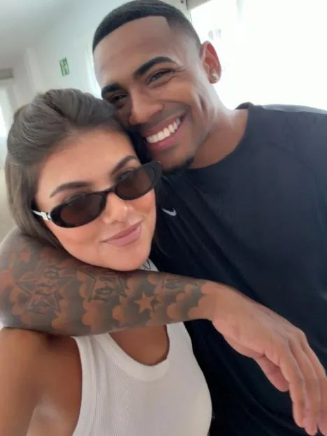 Samie Elishi poses with a partner during her first trimester of pregnancy.