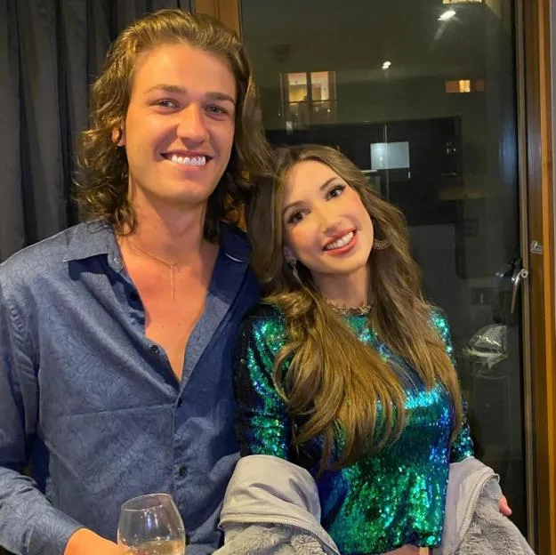 Nathan King and Rosie Williams pose together, smiling at the camera.