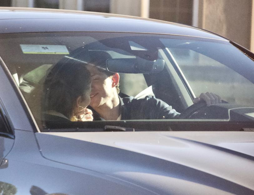 Zendaya and Tom Holland kissing in a car.