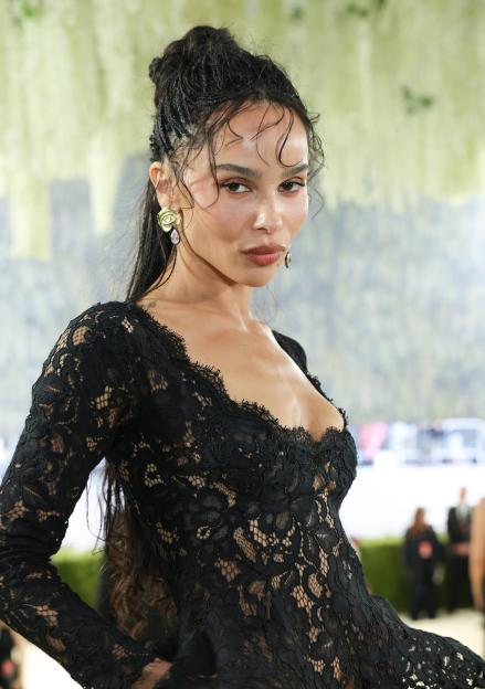 Zoë Kravitz attends the Met Gala in a black lace gown.