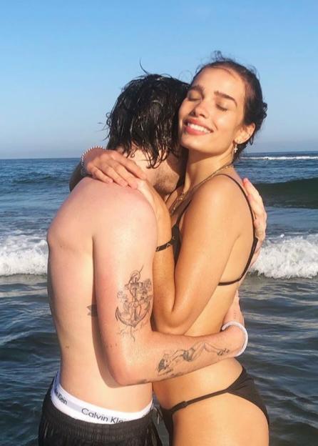 Brooklyn Beckham and Hana Cross embracing in the ocean.