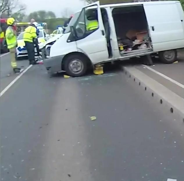 A crashed white van with emergency personnel on the road after a drunk driving incident.