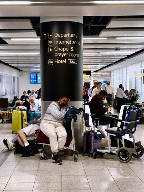Travelers wait at Gatwick Airport after flights were grounded due to a technical failure.