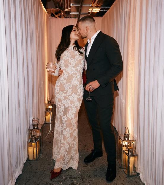 Adam Peaty and Holly Ramsay sharing an embrace at their engagement party.