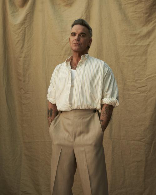Robbie Williams poses for a press photo.