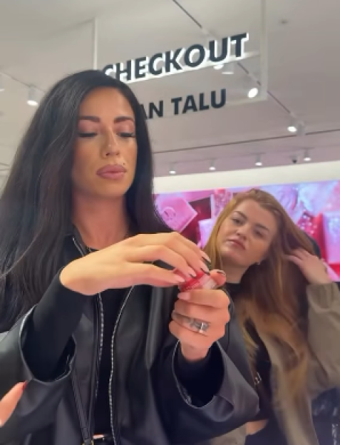 Woman opening a makeup product.