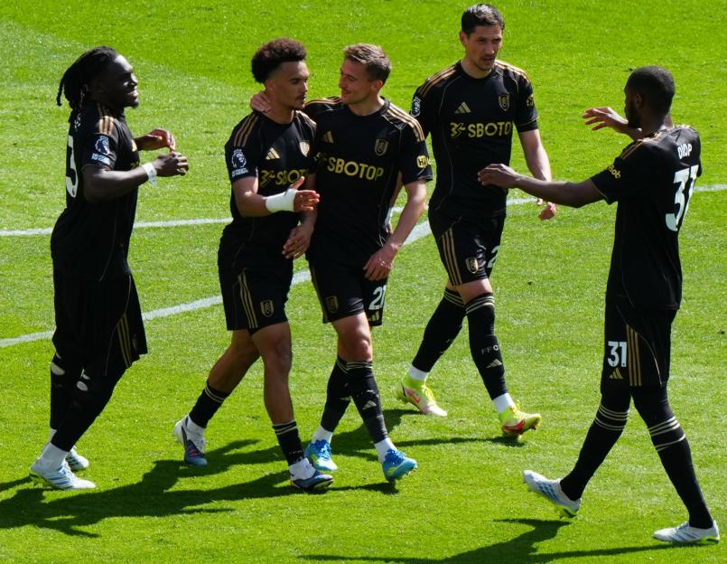 Antonee Robinson and other Fulham players celebrate his equalizing penalty kick.