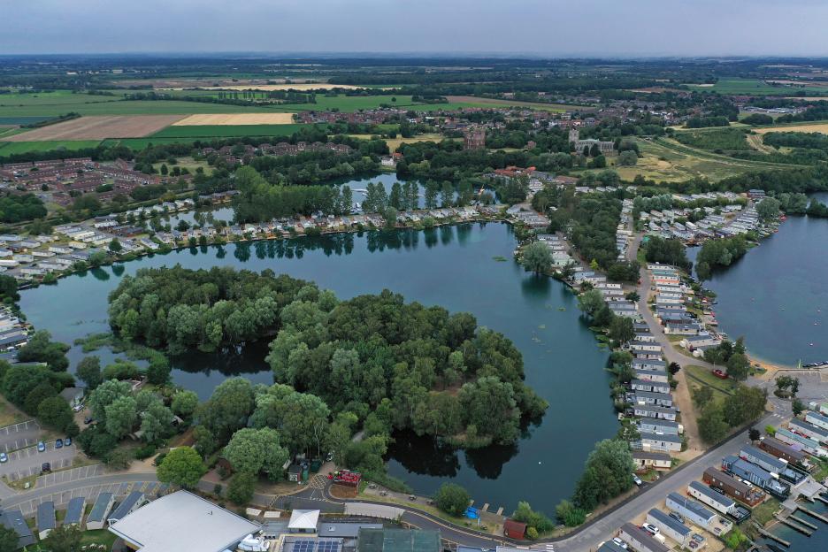Aerial view of Tattershall Lakes with caravans and houses surrounding the lake.