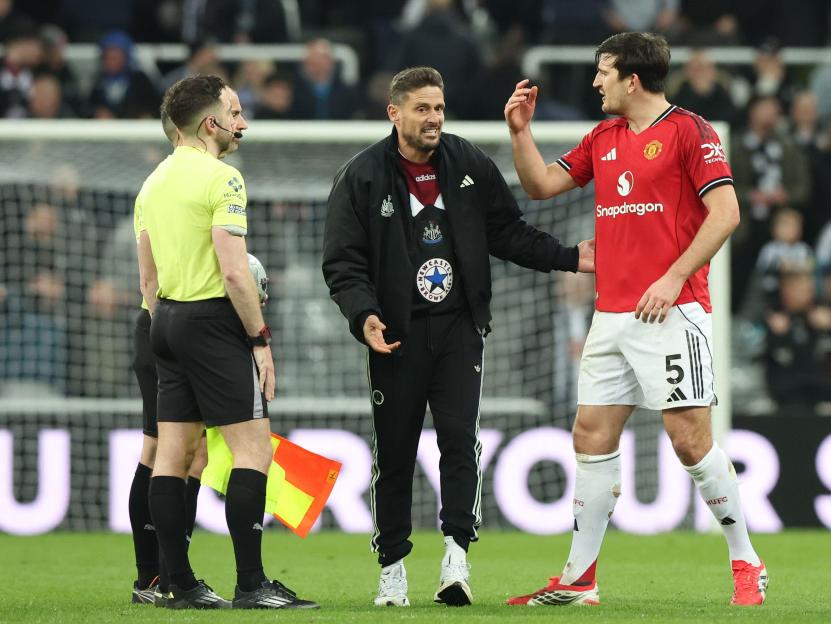Jason Tindall and Harry Maguire exchange words at the end of the Newcastle United vs Manchester United Premier League match.
