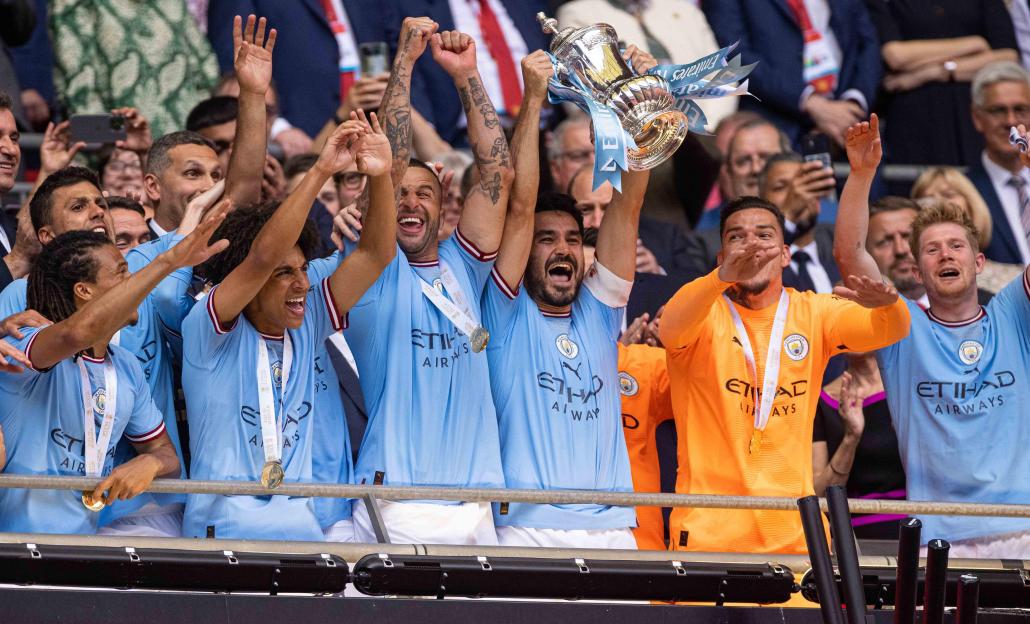 London, UK. 4th June, 2023. Manchester City's Ilkay Gundogan (3rd R) celebrates as he lifts the trophy after the FA Cup Final match between Manchester City and Manchester United in London, Britain, on June. 3, 2023. Man City won 2-1. Credit: Xinhua/A