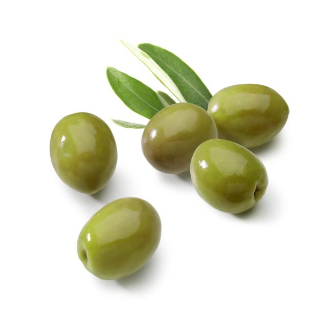 Green olives with olive leaves.