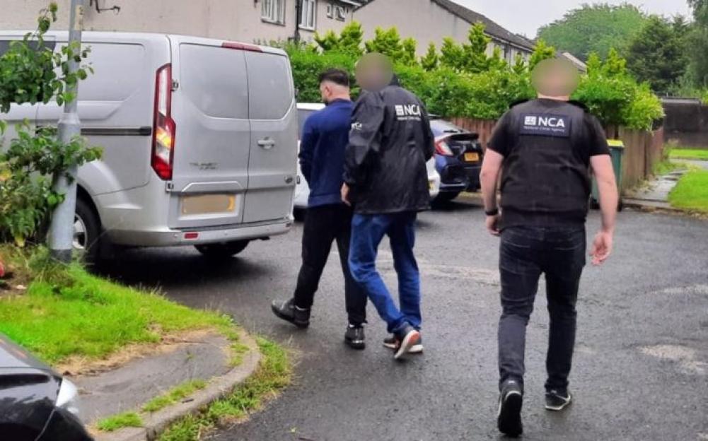 Ahmadi being arrested by National Crime Agency staff at an address in Ingol.