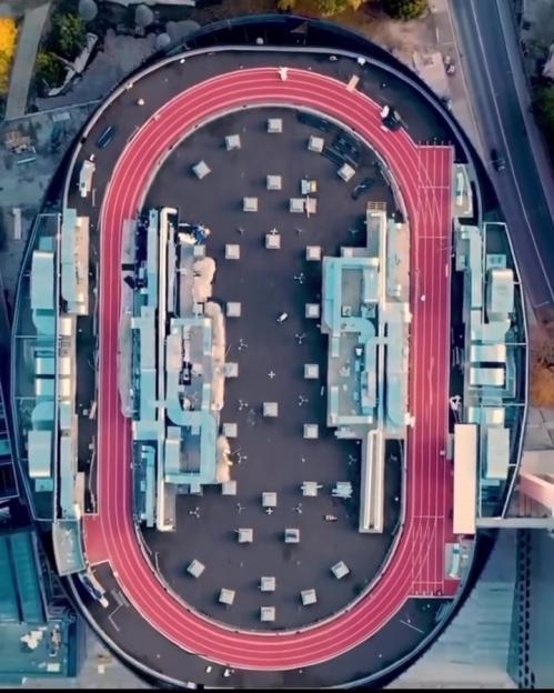 Aerial view of a stadium with a running track on its roof.