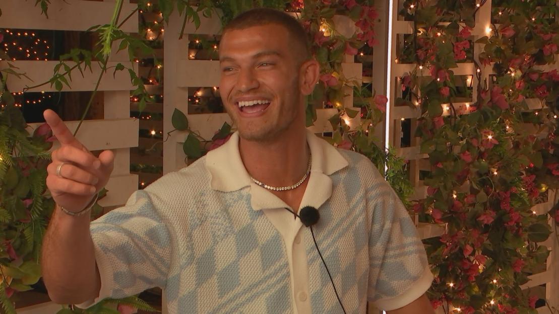 Blu Chegini from Love Island laughing and pointing.
