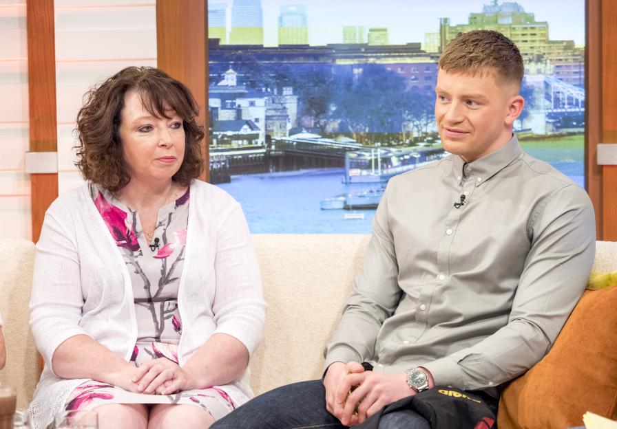 Caroline Peaty and Adam Peaty sitting on a couch.