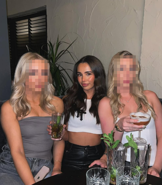 Lara Grace with two friends at a bar.