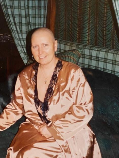 Debbie Douglas smiling while wearing a peach robe.