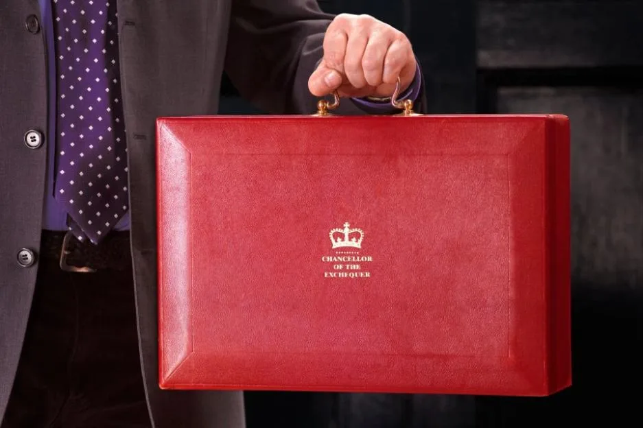 The Chancellor of the Exchequer holding the red budget box.