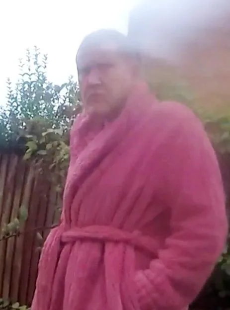 Jayden Mannion-Roberts, wearing a pink robe, is arrested by police.