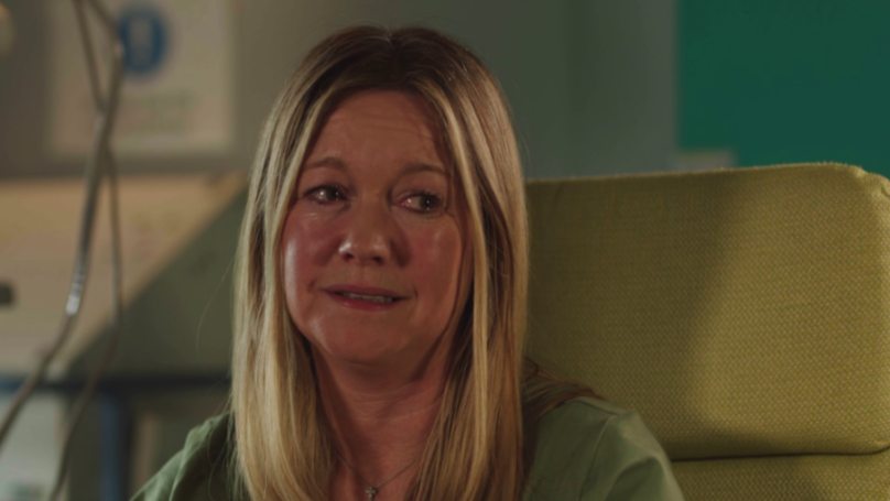 A woman with long blonde hair looks distressed.