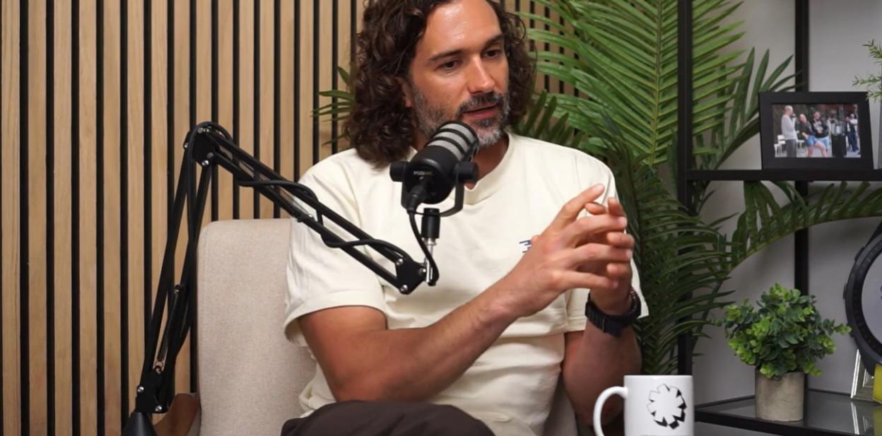 Joe Wicks talking into a podcast microphone.